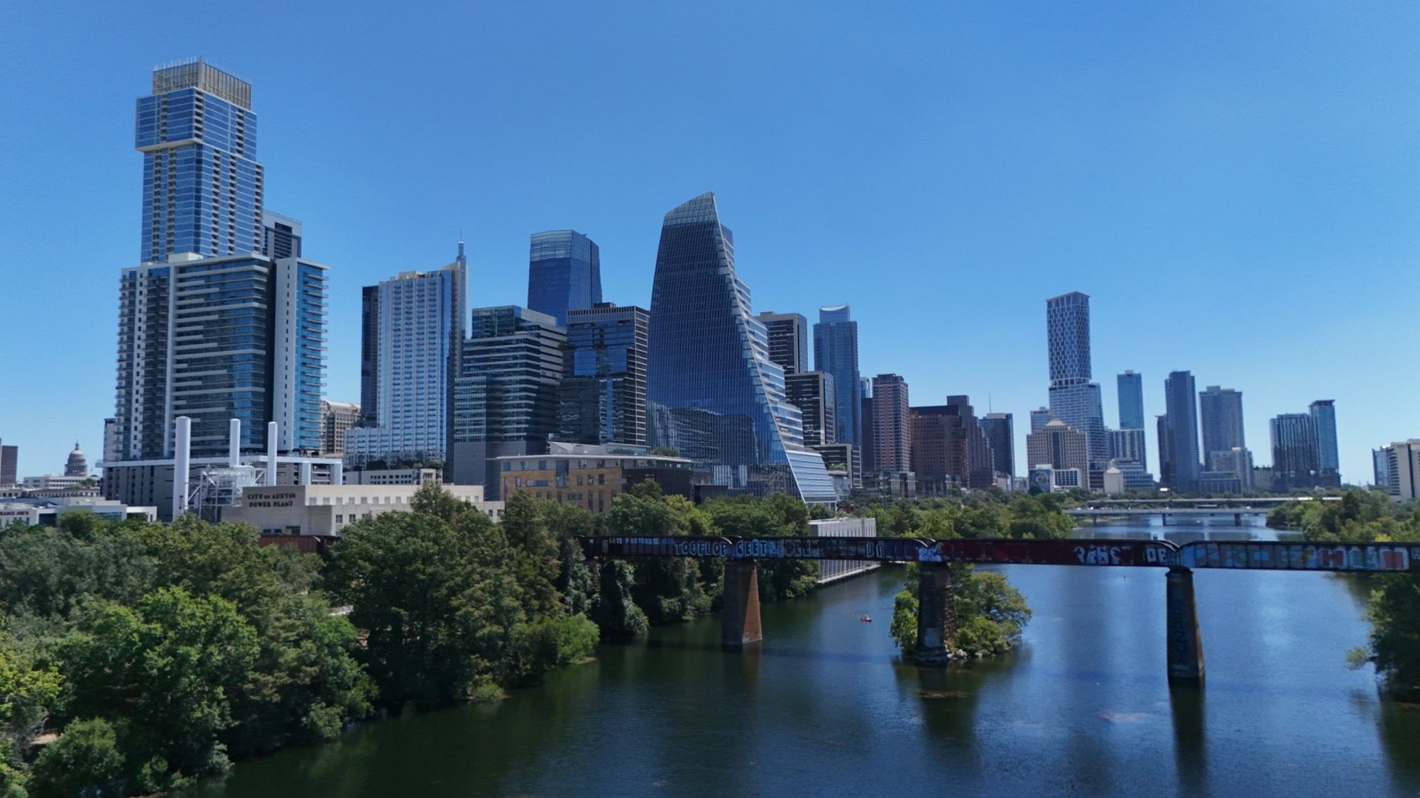 Downtown Austin skyline above Lady Bird Lake and the rail bridge